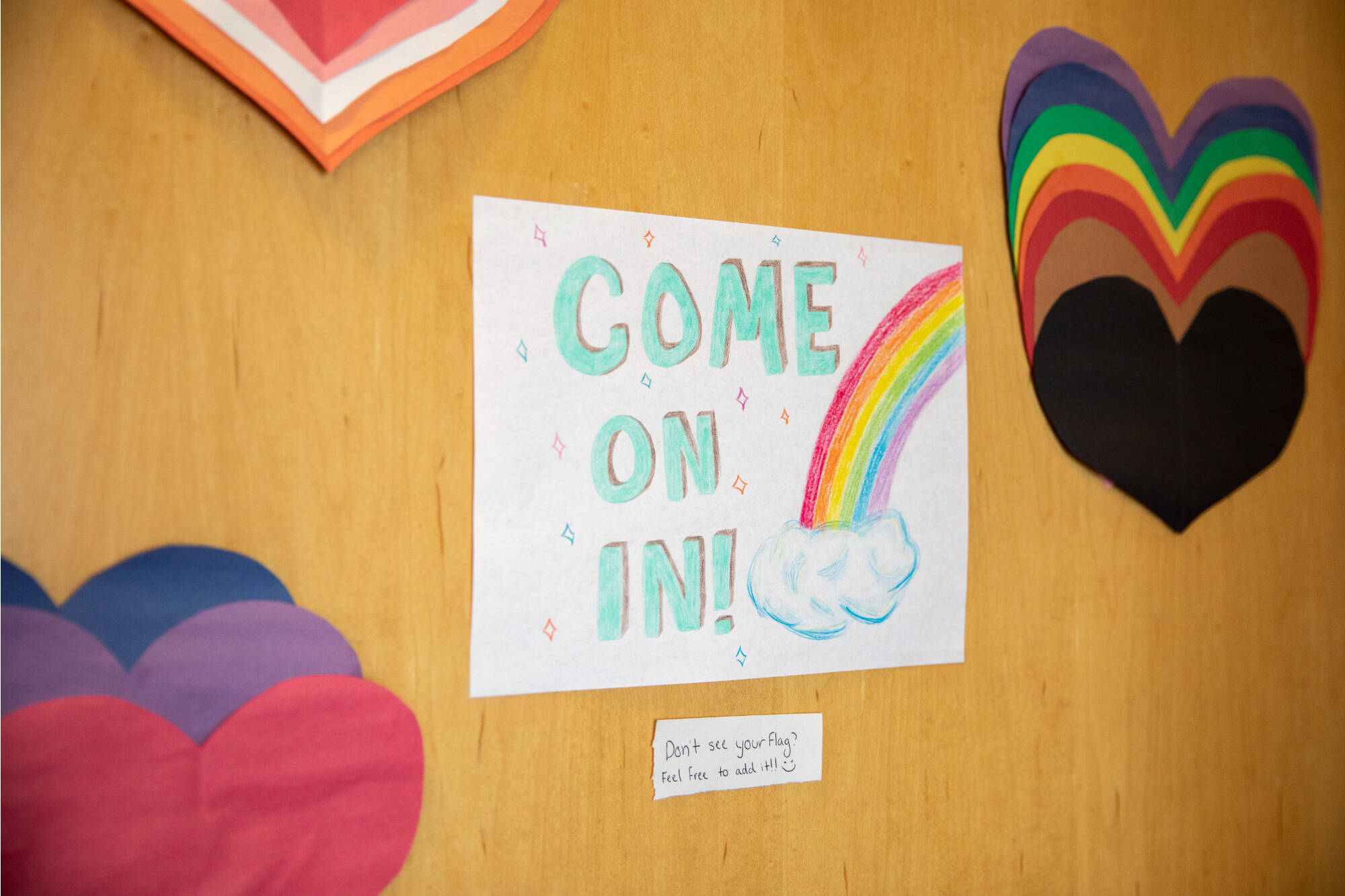 A colorful sign on the door welcomes students to the Milton E. Ford LGBT Resource Center.